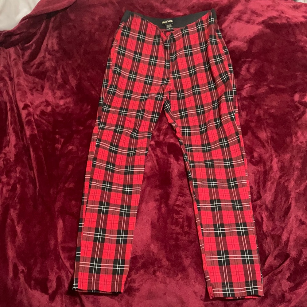 Red black and white pants that requires no belt and stops right about the ankle.